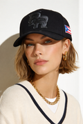 Woman wearing a black cap with a logo and American flag patch, white background