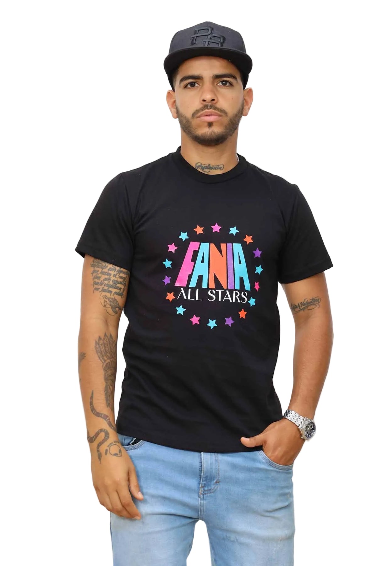 Man wearing a black t-shirt with colorful text and stars, standing against a white wall.