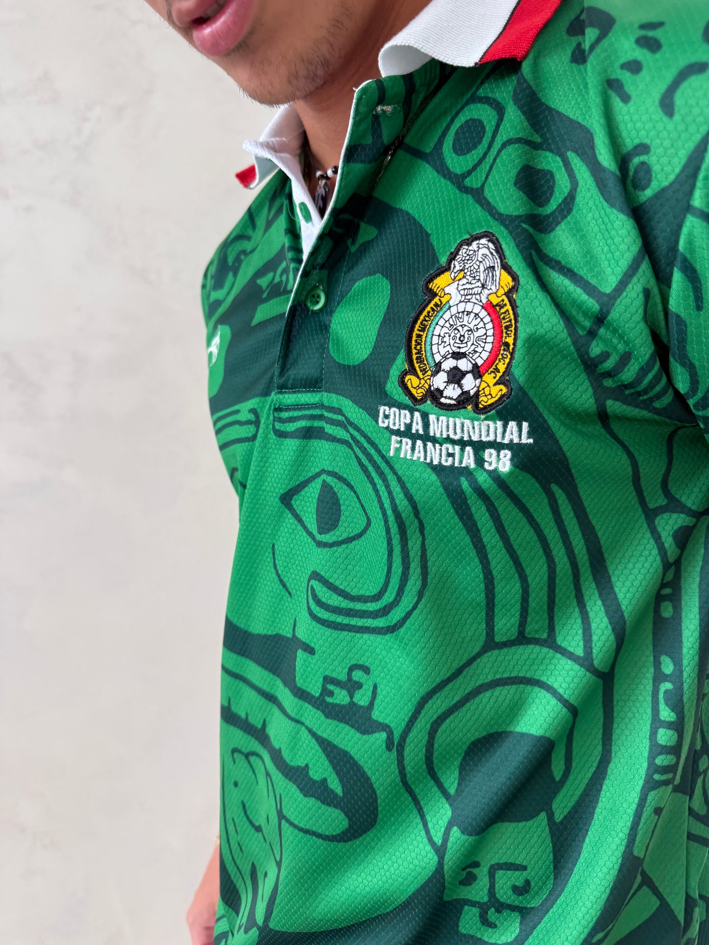 Aztec-inspired green polo jersey front view on male model
