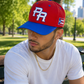 Front angled view of PR Heritage Snapback Hat with premium curved brim constructio