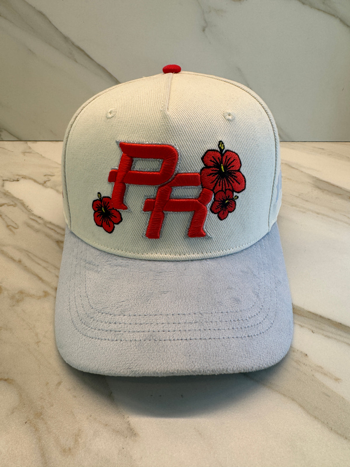 Ivory silver Puerto Rico floral snapback hat with velvet brim, 3D PR embroidery, Puerto Rico flag patch and tropical flower details from the Encanto PR Collection.