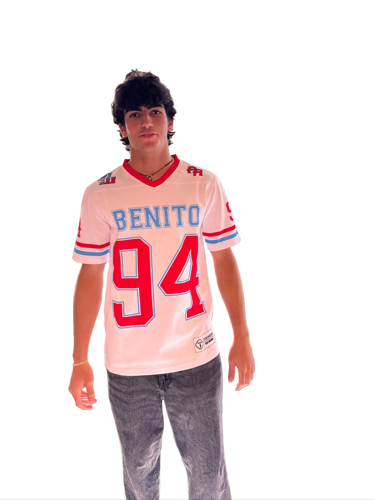 Person wearing a sports jersey with 'BENITO' and number '46' in a room with large windows.