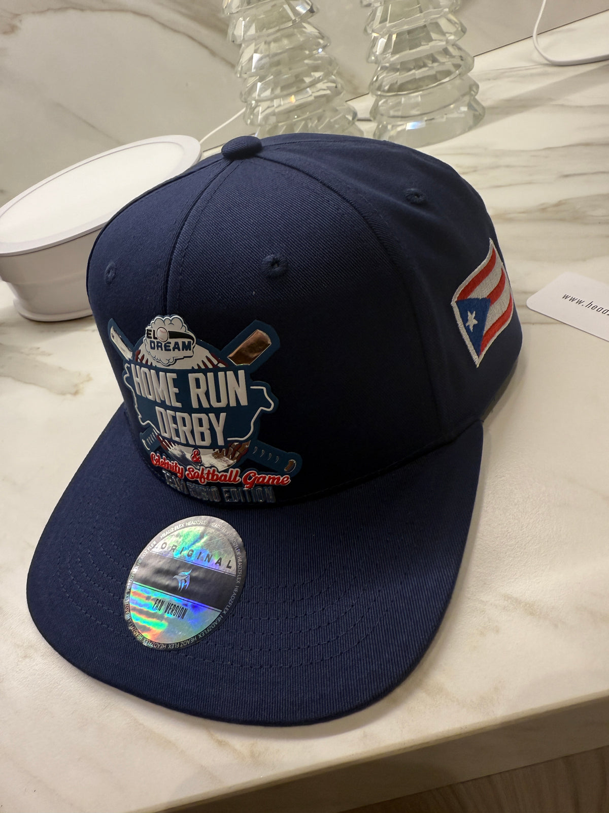 Blue cap with decorative patches on a white surface