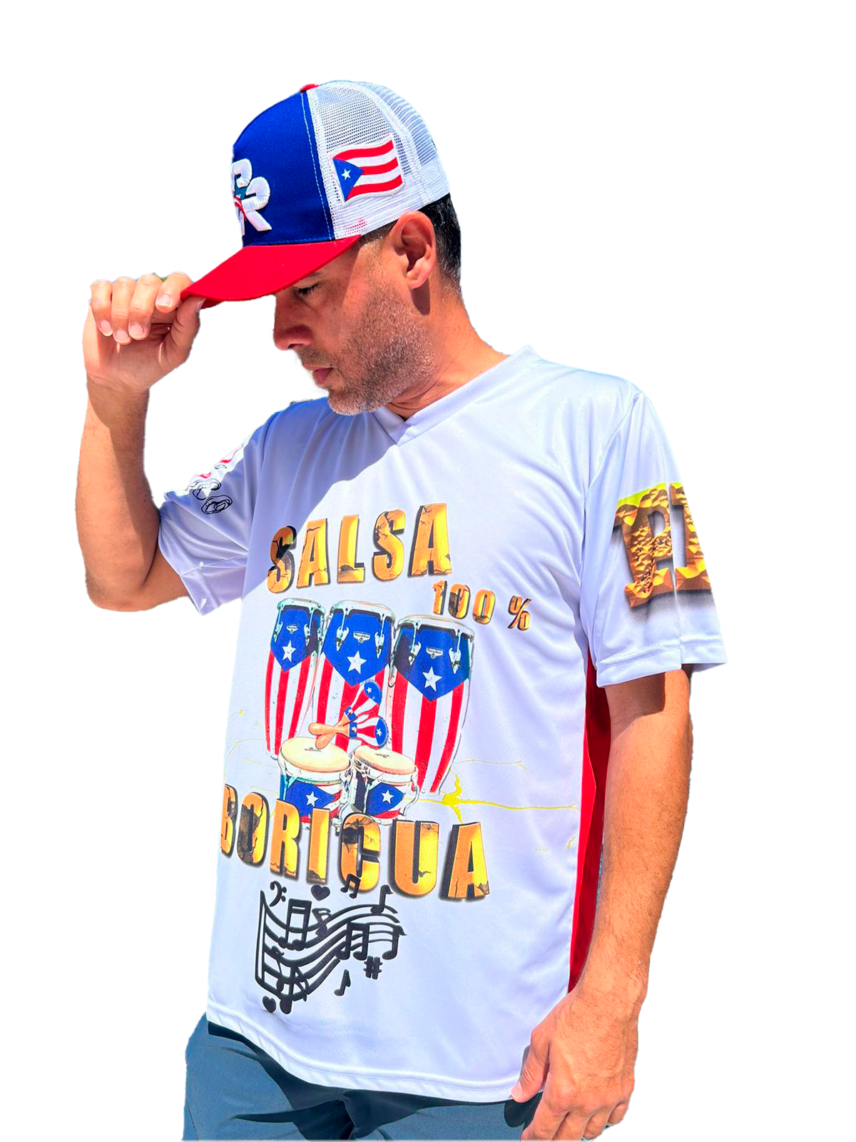 Man wearing a white t-shirt with colorful text and graphics, holding a cap with Puerto Rican flag design.