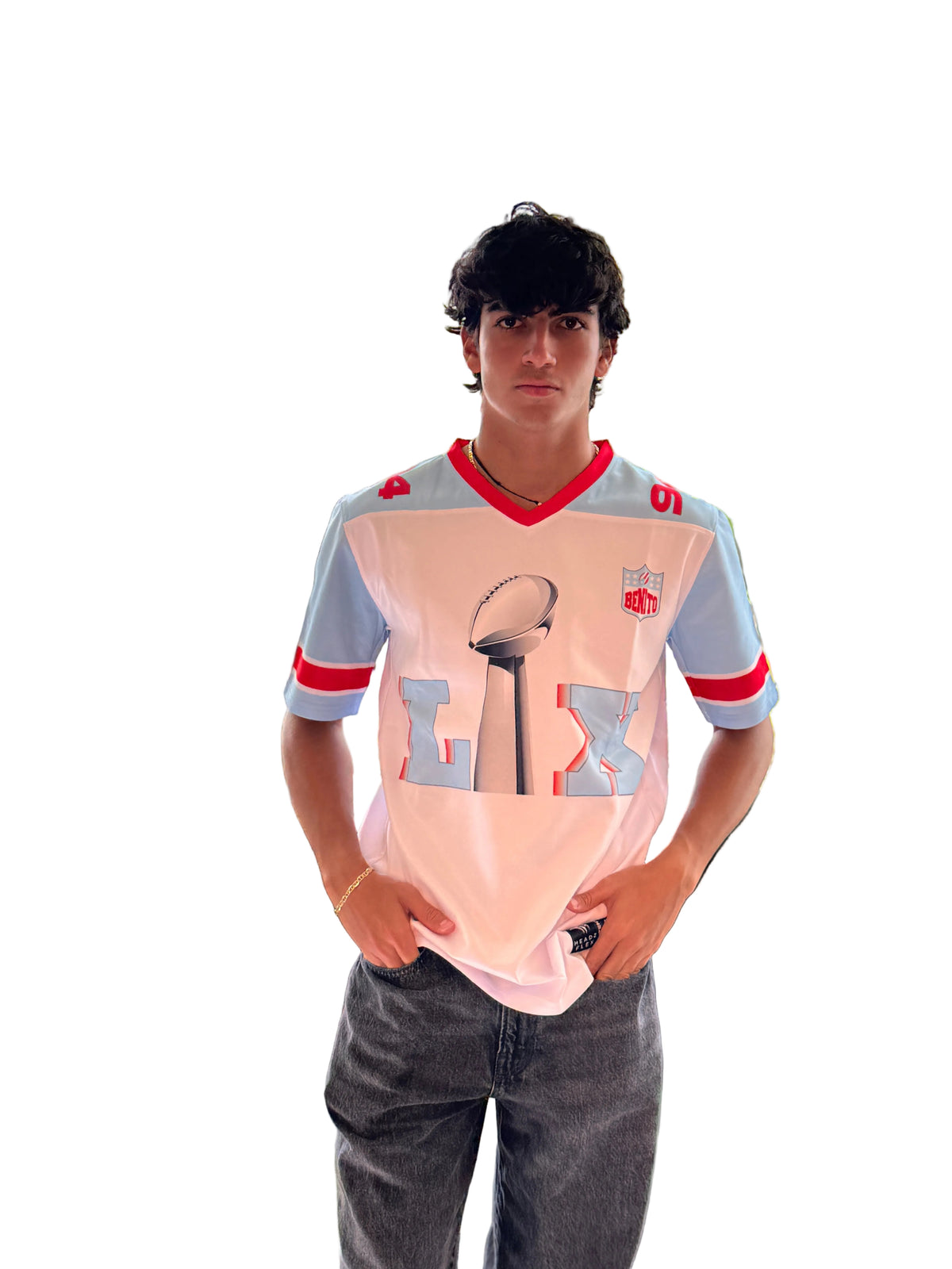 Person wearing a sports jersey with a graphic design in an indoor setting with large windows showing greenery outside.