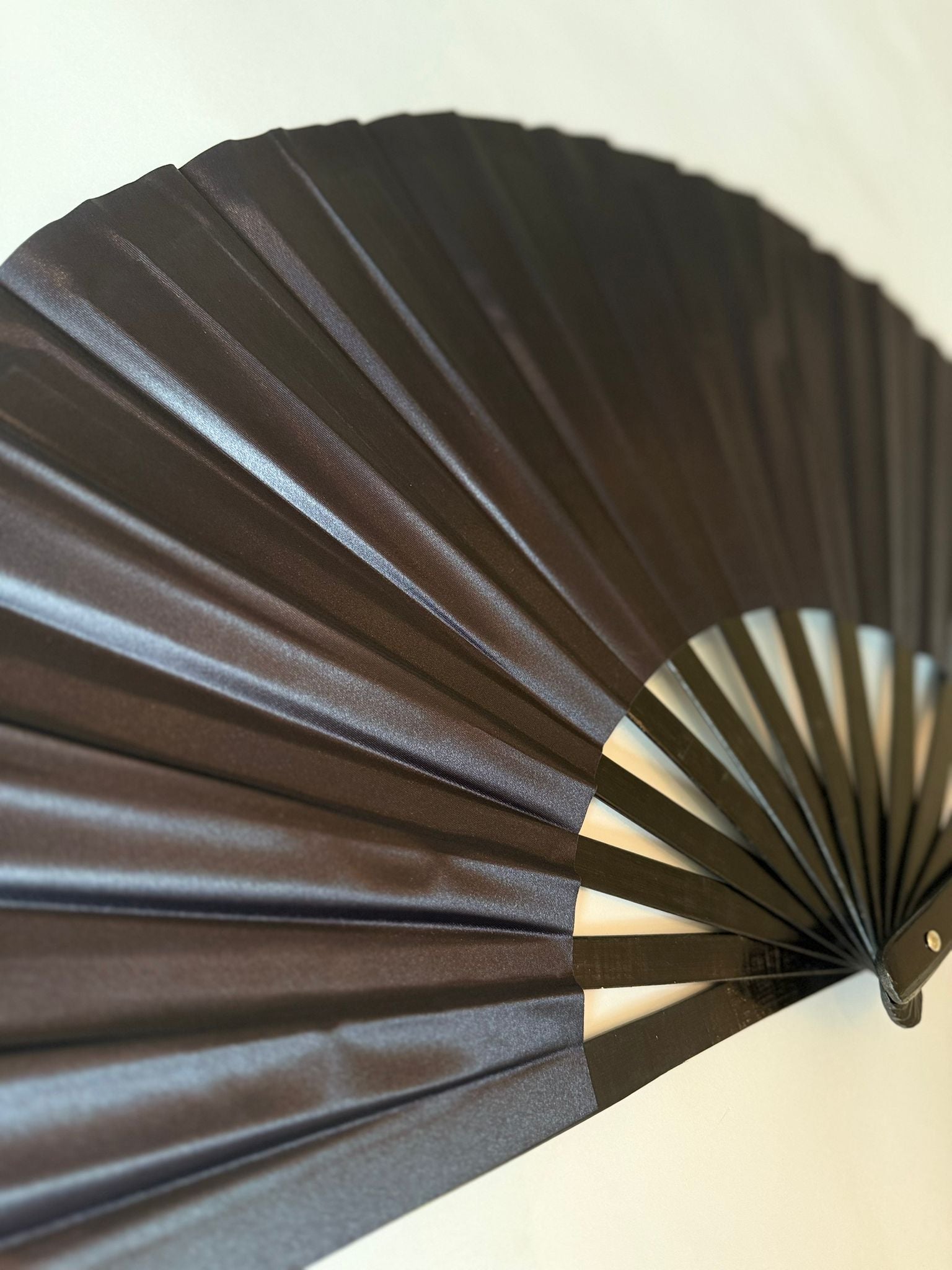 Solid black folding hand fan for parties and festivals